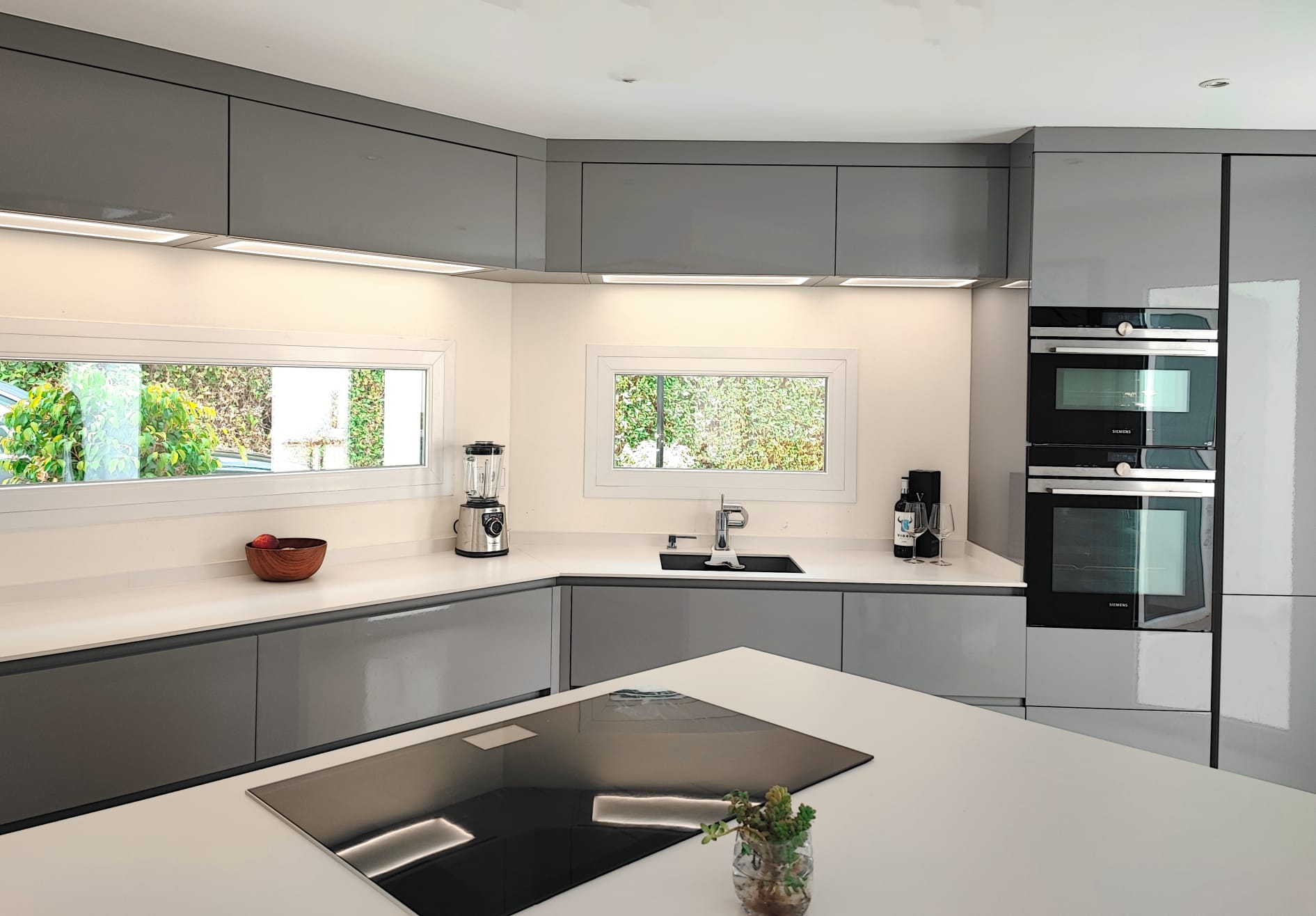 Contemporary kitchen with island, Siemens appliances and garden views